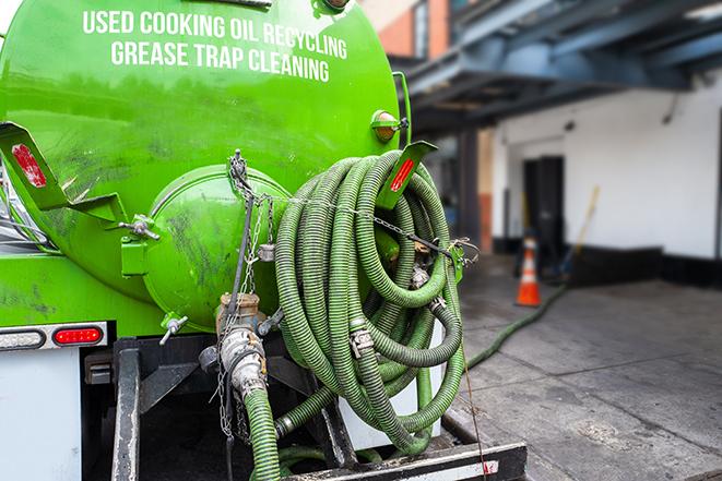 a grease trap being pumped by a sanitation technician in Plainfield IL